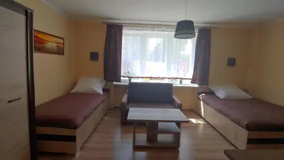 a room with a couch and a chair and a window at Róża Pustyni in Chrzanów