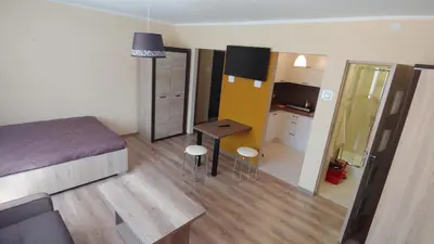 a bedroom with a bed and a desk and a mirror at Róża Pustyni in Chrzanów
