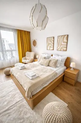a bedroom with a large bed and a chair at InPoint Mogilska Tower City View Apartments near Tauron Arena Self Check-in in Kraków