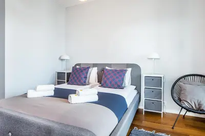 a bedroom with a large bed with towels on it at InPoint Mogilska Tower City View Apartments near Tauron Arena Self Check-in in Kraków