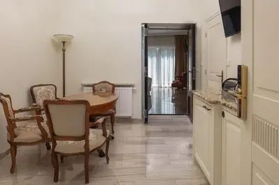 a kitchen with a table and chairs in a room at Apartamenty Pod Baranem in Kraków