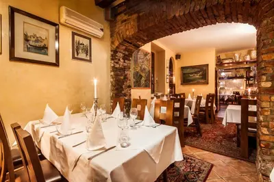 a dining room with a table with white table cloth at Apartamenty Pod Baranem in Kraków