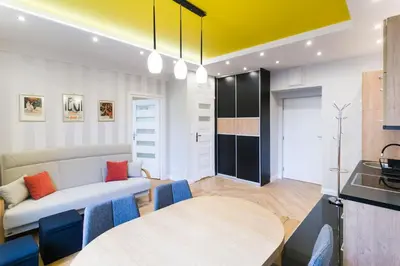 a living room with a couch and a table at Apartament przy Parku Krakowskim in Kraków