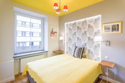 a bedroom with a bed and a window at Apartament przy Parku Krakowskim in Kraków