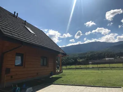 a log cabin with a rainbow in the sky at Miętusowa Chata pod Babią in Zawoja