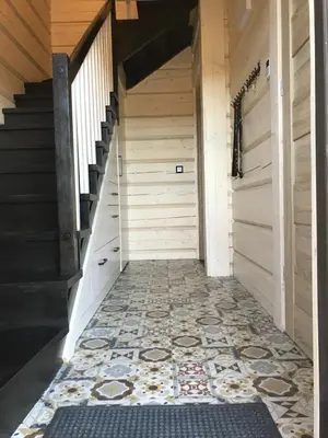 a hallway with a tile floor and stairs at Miętusowa Chata pod Babią in Zawoja