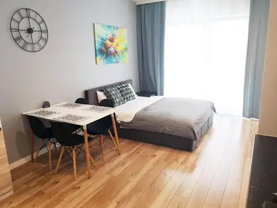 a bedroom with a bed and a table with chairs at NOVUM Apartment with Parking in Kraków