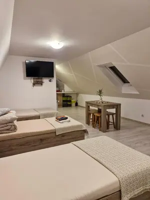 a living room with two beds and a table at Zakątek DoriMaks in Zawoja