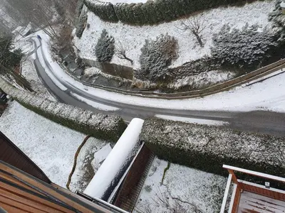a road with snow on the ground next to a house at Zakątek DoriMaks in Zawoja