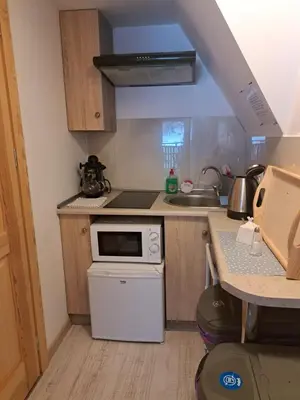 a small kitchen with a stove and a sink at Zakątek DoriMaks in Zawoja