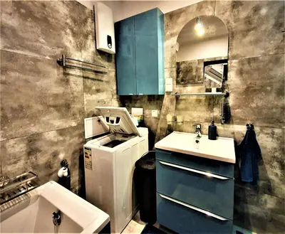 a small kitchen with blue cabinets and a sink at GAJ Apartment - Air condition, free parking in Kraków
