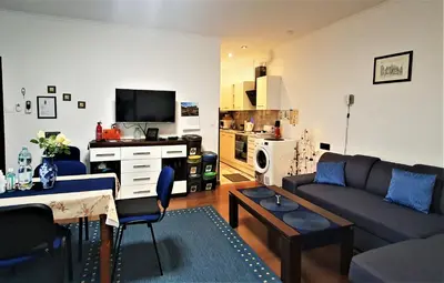 a living room with a couch and a table at GAJ Apartment - Air condition, free parking in Kraków