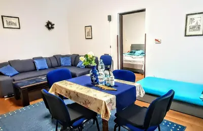 a living room with a table and a couch at GAJ Apartment - Air condition, free parking in Kraków