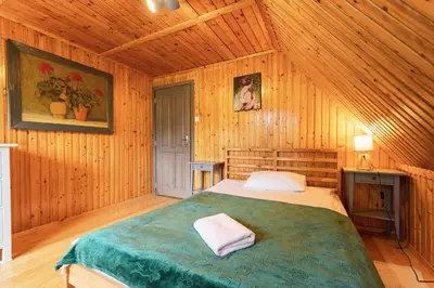 a bedroom with a bed in a wooden room at Willa Lavinka z sauną in Zawoja