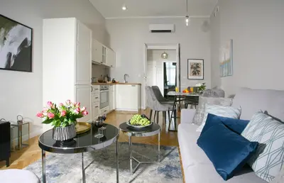 a living room with a couch and a table at Gem Apartment by Castle (Old Town Krakow) in Kraków