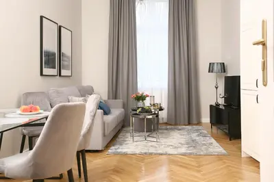 a living room with a couch and a table at Gem Apartment by Castle (Old Town Krakow) in Kraków