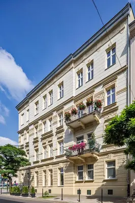 a large white building with flower boxes on it at Gem Apartment by Castle (Old Town Krakow) in Kraków
