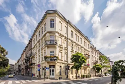a large white building on the side of a street at Gem Apartment by Castle (Old Town Krakow) in Kraków