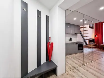 a red umbrella sitting on a bench in a kitchen at LOFT-to-be Apartment in Kraków