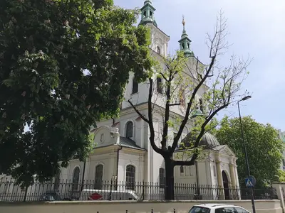 a large white building with a tree in front of it at LOFT-to-be Apartment in Kraków