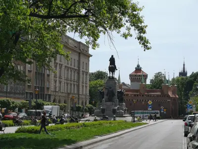 a statue of a man on a horse in front of a building at LOFT-to-be Apartment in Kraków