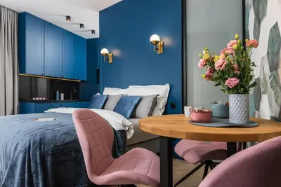 a bedroom with a bed and a table with chairs at NEARTOpl Rakowicka apartments Parking in Kraków