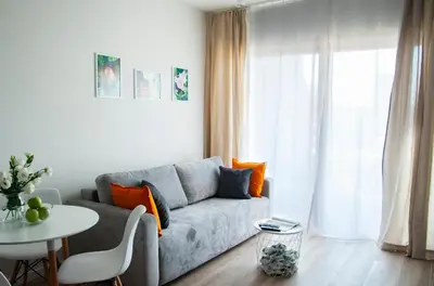 a living room with a couch and a table at NEARTOpl Rakowicka apartments Parking in Kraków