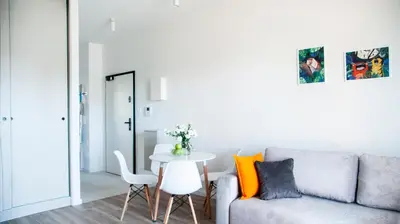 a living room with a couch and a table at NEARTOpl Rakowicka apartments Parking in Kraków