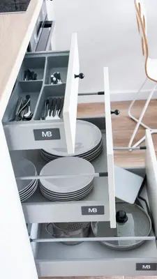 a kitchen drawer with plates and utensils at NEARTOpl Rakowicka apartments Parking in Kraków