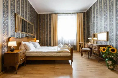 a bedroom with a bed and a desk and a dresser at Vintage Senacka 5 Apartments in Kraków
