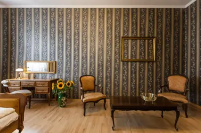 a room with a table and chairs and a desk at Vintage Senacka 5 Apartments in Kraków