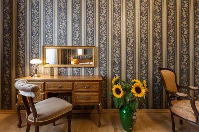 a desk with a mirror and a vase with sunflowers at Vintage Senacka 5 Apartments in Kraków