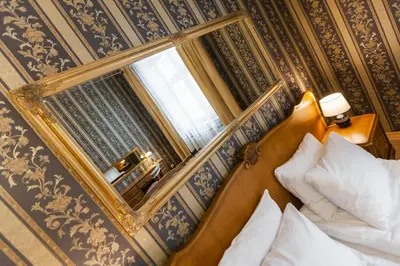 a bedroom with a mirror and a bed in it at Vintage Senacka 5 Apartments in Kraków