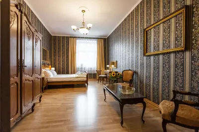 a living room with a bed and a table at Vintage Senacka 5 Apartments in Kraków