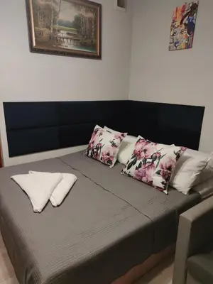a bed with pillows on it in a room at Pokoje nad Rabą in Myślenice