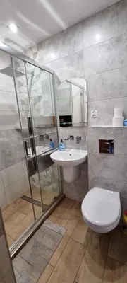 a bathroom with a shower and a toilet and a sink at Pokoje nad Rabą in Myślenice