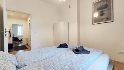a bedroom with a bed with two hats on it at Barska 21 by Homeprime in Kraków