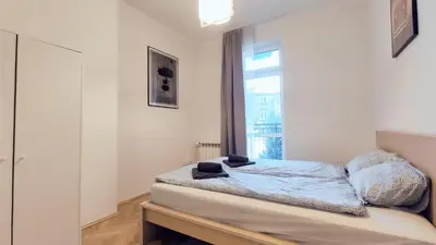 a bedroom with a bed and a window at Barska 21 by Homeprime in Kraków
