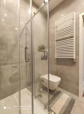 a bathroom with a toilet and a glass shower at Barska 21 by Homeprime in Kraków
