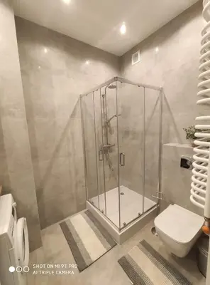 a shower stall in a bathroom with a toilet at Barska 21 by Homeprime in Kraków