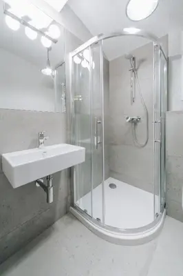 a bathroom with a shower and a sink at M3 Main Square Studio in Kraków