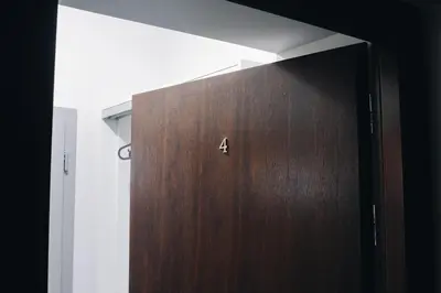 a wooden door with the number four on it in a room at M4 Main Square Studio in Kraków