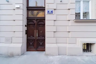 a wooden door on a building with a sign on it at Forest Nook Main Square Loft in Kraków