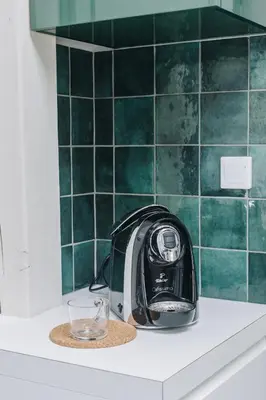 a toaster sitting on top of a counter with a glass at Forest Nook Main Square Loft in Kraków