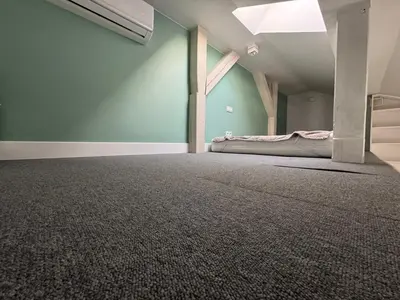 an empty room with a bed in the corner at Forest Nook Main Square Loft in Kraków