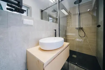a bathroom with a sink and a shower at Forest Nook Main Square Loft in Kraków