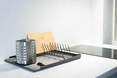 a metal dish rack on a counter with chopsticks at M5 Main Square Stylish One Bedroom in Kraków