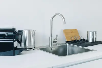 a kitchen counter with a sink and a coffee maker at M5 Main Square Stylish One Bedroom in Kraków
