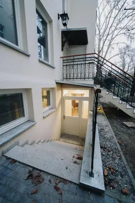 a front door of a house with a balcony at M6 Main Square Stylish One Bedroom in Kraków