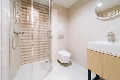 a bathroom with a shower and a toilet and a sink at M6 Main Square Stylish One Bedroom in Kraków